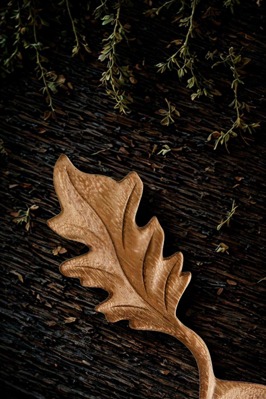 Close-up of oak leaf handle on wooden spoon