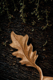 Close-up of oak leaf handle on wooden spoon