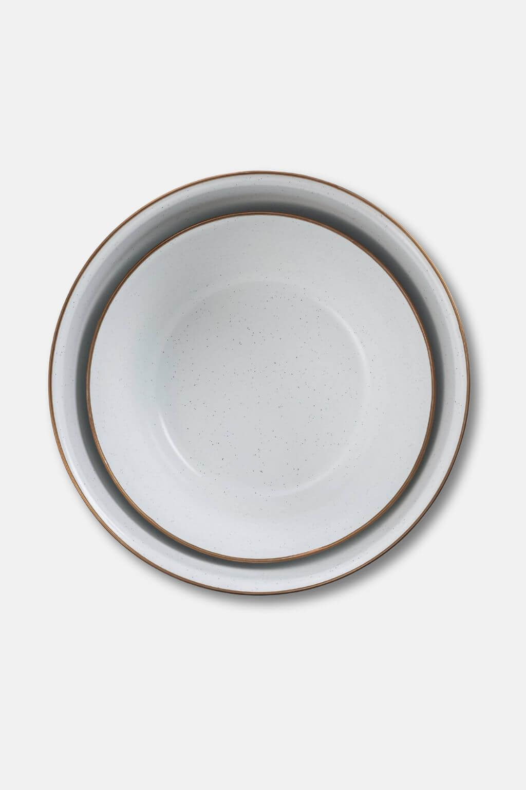 Nested enamel bowls with bronze rims viewed from above