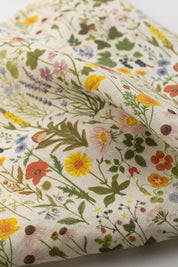 Close-up of Botanist Linen Tea Towel texture with vibrant flora and fauna design.