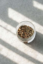 Overhead view of Anti-Inflammatea herbal tea leaves in open glass jar