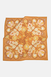Autumn-inspired cotton bandana with pressed flower pattern in warm golden hues.