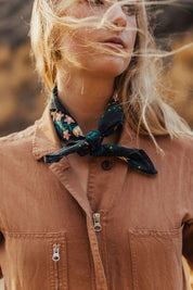 Model wearing Betty Bandana tied around neck with wind blowing through hair
