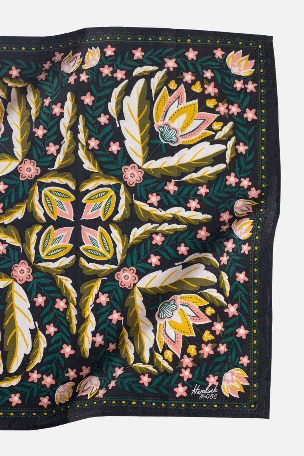Close-up of Hemlock Betty Bandana floral pattern in gold, pink, and green on black background