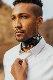 Man wearing Betty Bandana styled as a neck scarf outdoors