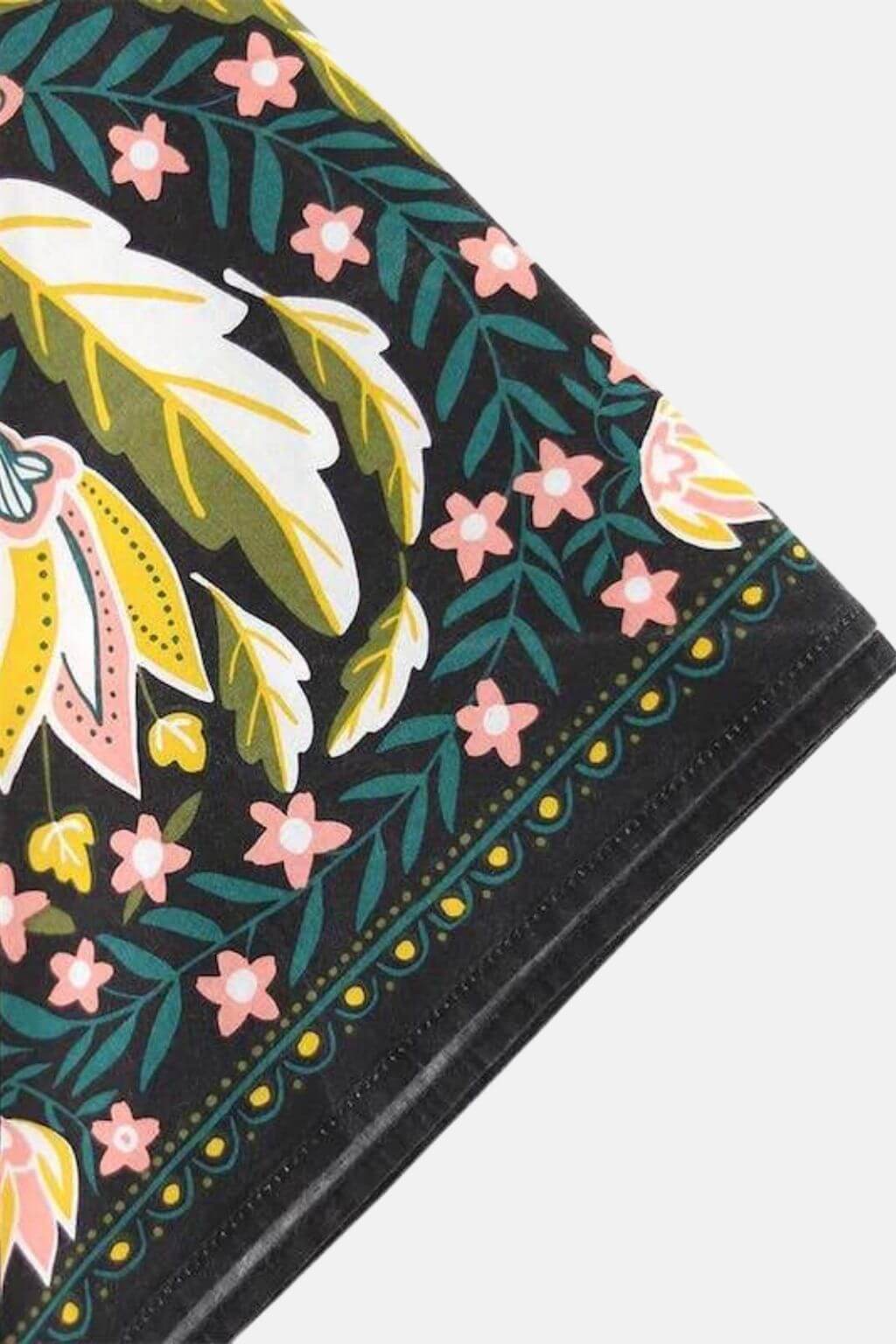 Detail of Betty Bandana fabric corner with floral accents and border design