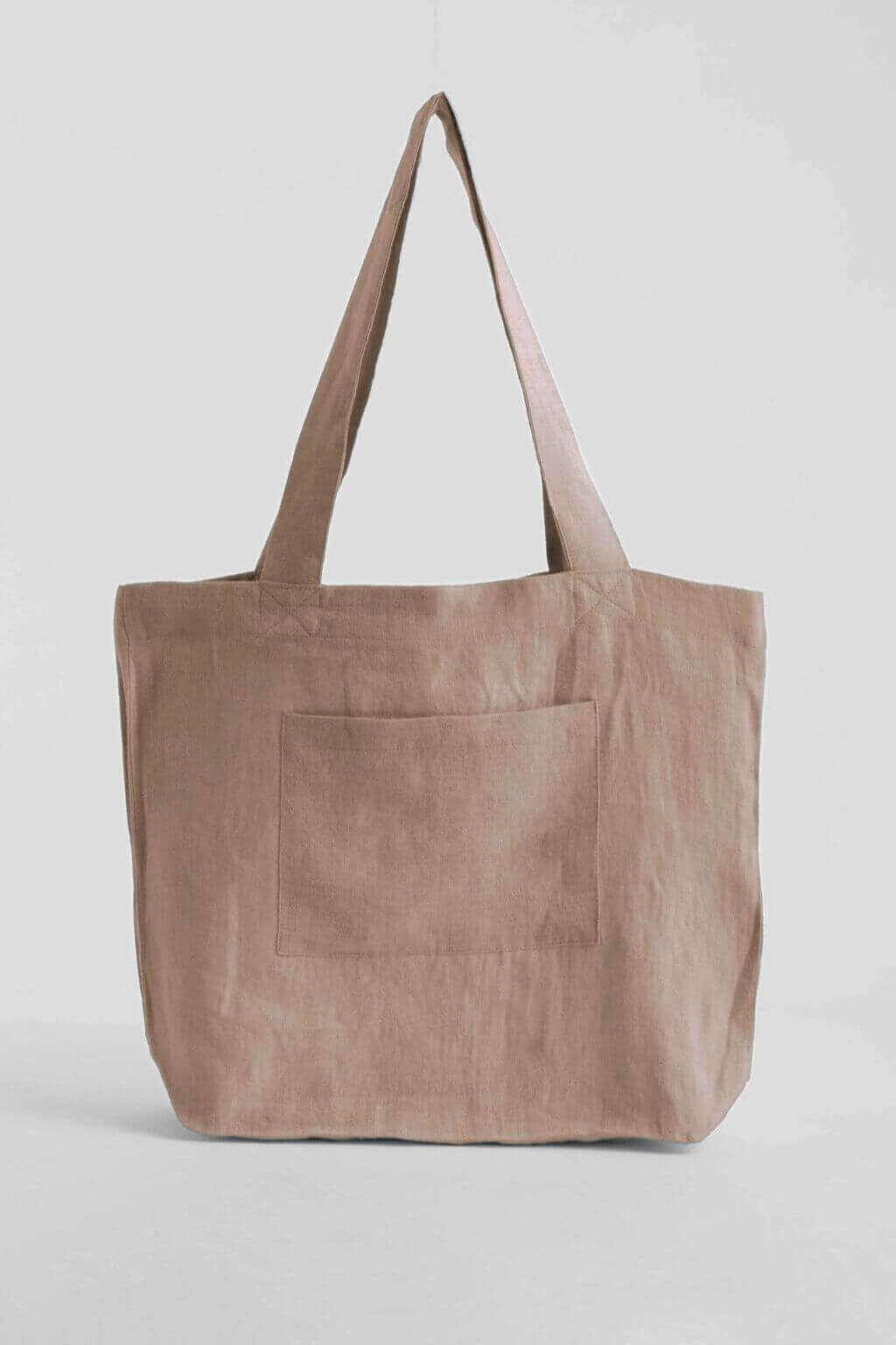 Sandy beige linen tote bag with front pocket.
