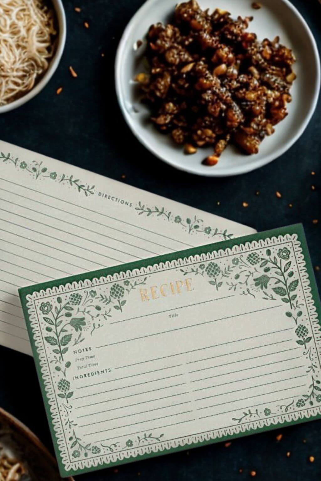 Artichoke Recipe Card with plate of food and ingredients nearby