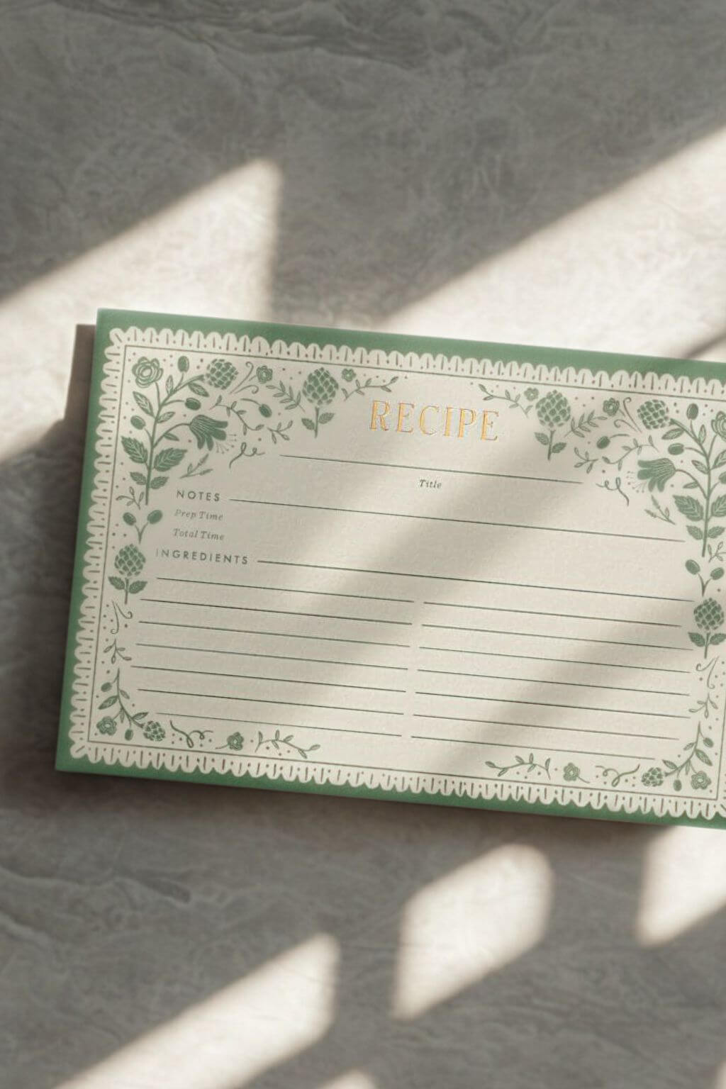 Rifle Paper Co. Artichoke Recipe Card with floral border in sunlight