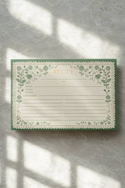 Rifle Paper Co. Recipe Card with artichoke floral border on textured surface