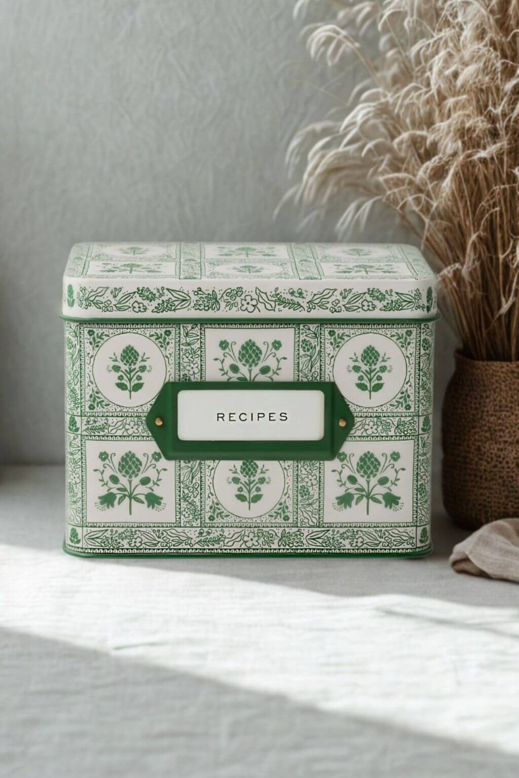 Rifle Paper Co. Artichoke Heirloom Recipe Tin styled on linen table beside dried grasses