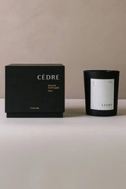 Minimalist product shot of Cedar Luxury Candle and box against a neutral background.