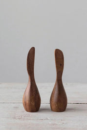 Pair of standing acacia wood canapé knives displayed on neutral tabletop.