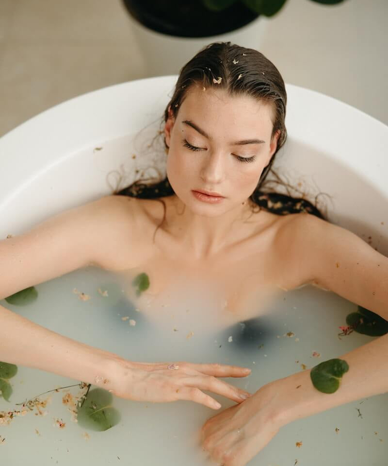 Cultiverre : Gifts for Self Care Collection - woman filling the bathtub with water