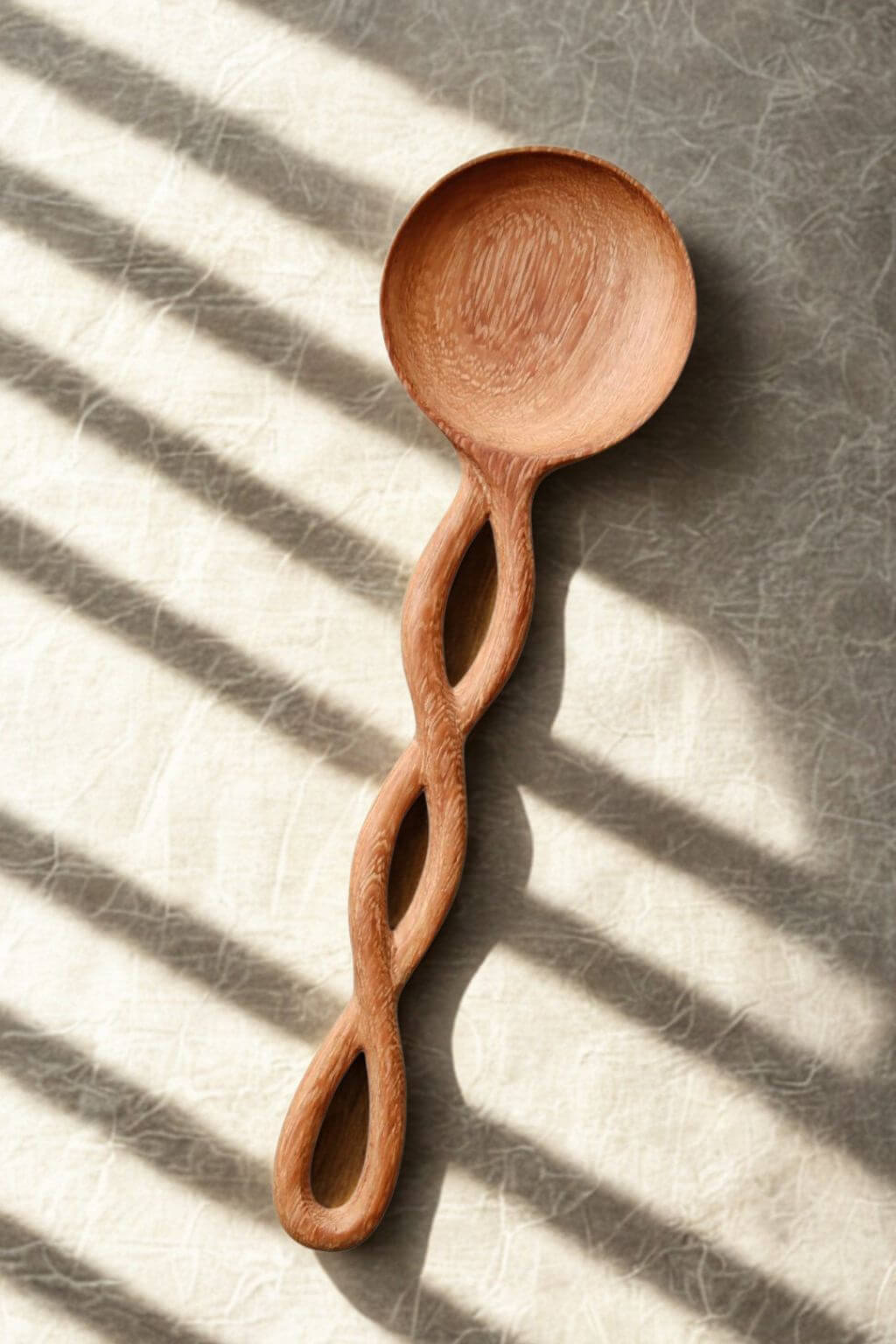 Close-up of artisan wooden spoon with spiral twisted handle.