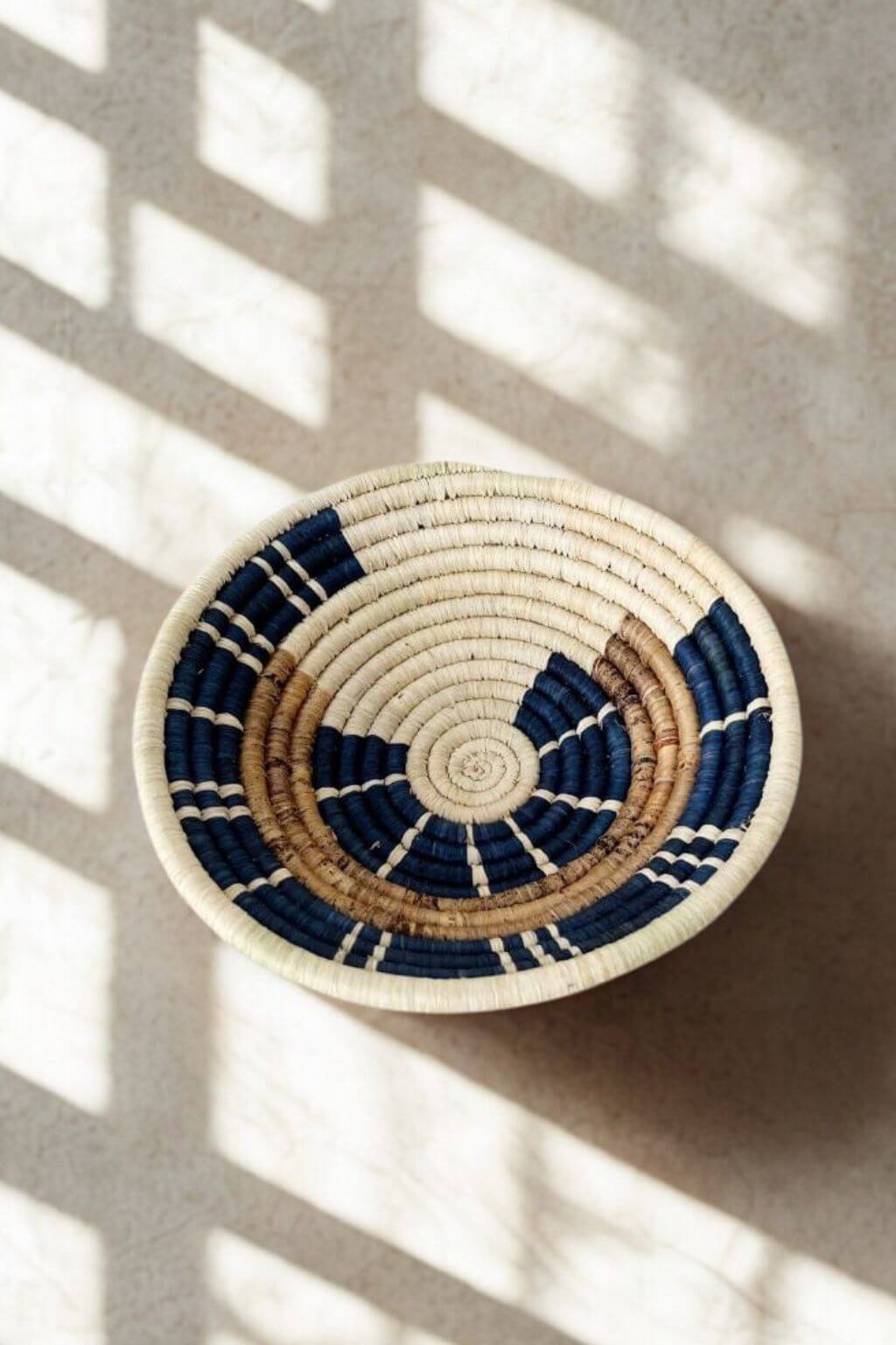 Handwoven blue and natural raffia bowl top view