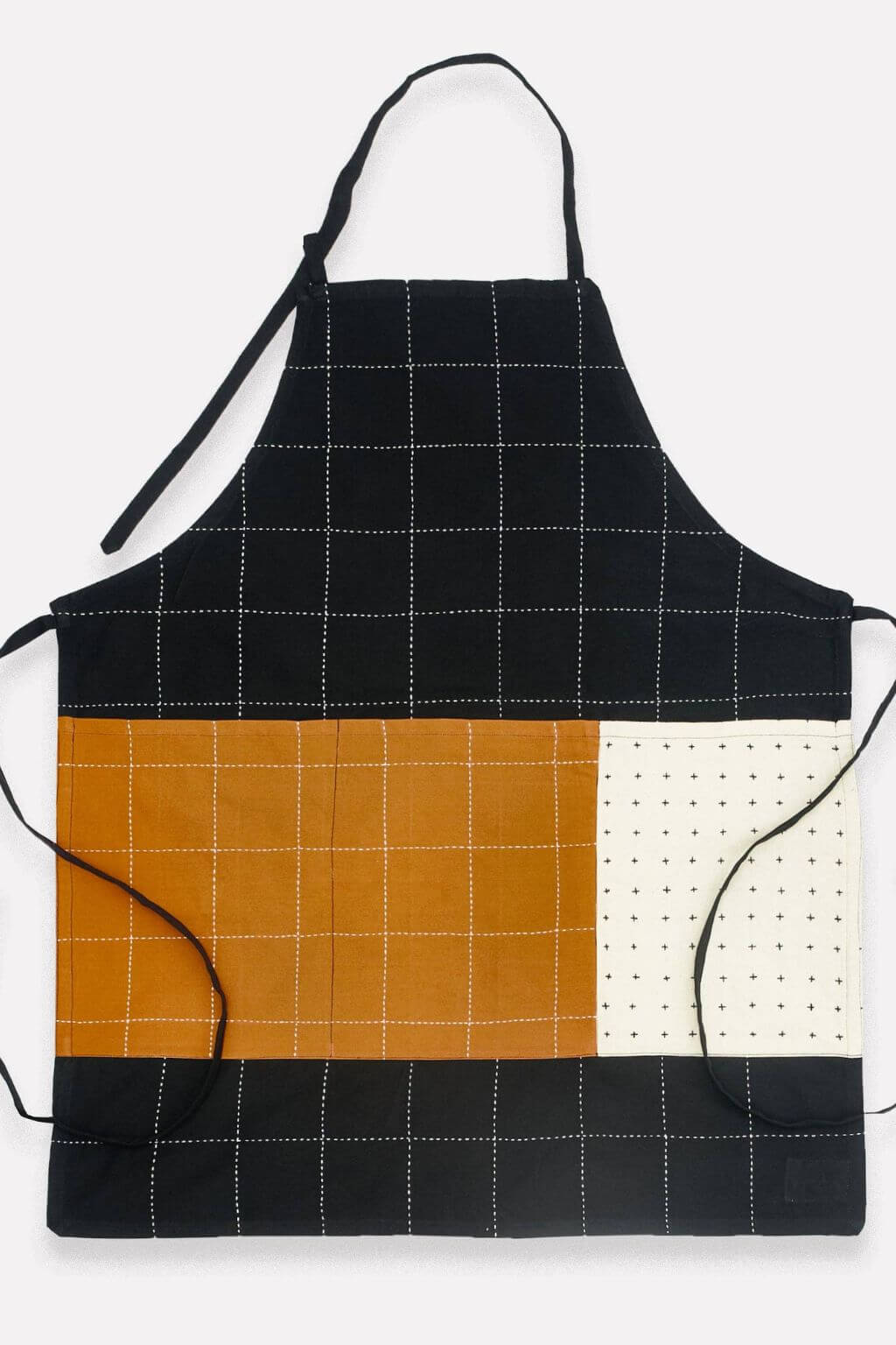 Black, orange, and white checkered apron on a white background