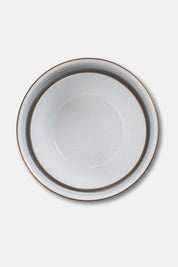 Nested enamel bowls with bronze rims viewed from above