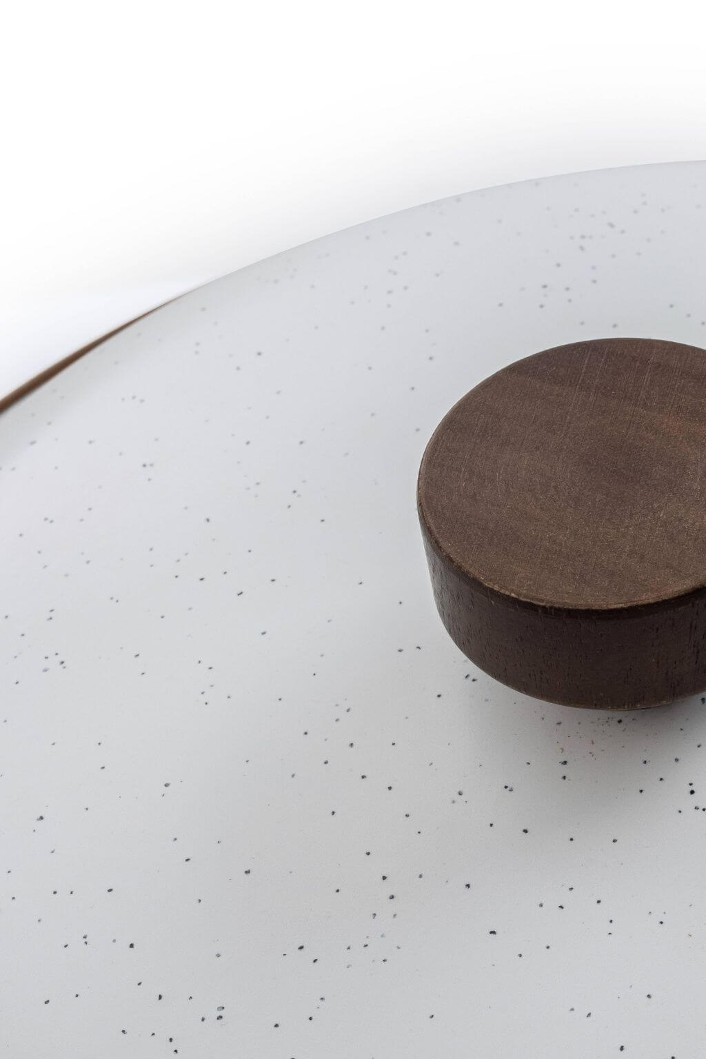 Close-up of walnut lid handle on eggshell enamel stock pot