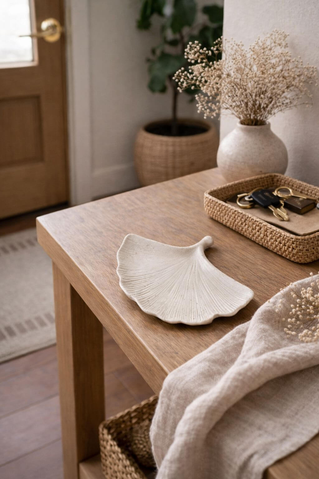 Handmade stone ginkgo leaf tray on wooden entry table