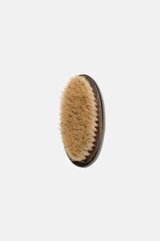 Natural bristle nail brush crafted from dark beechwood, close-up view