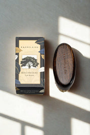 Baudelaire Beechwood Nail Brush beside gift box on sunlit surface