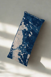 Indigo Splash Eye Pillow with blue and cream marbled pattern in soft light