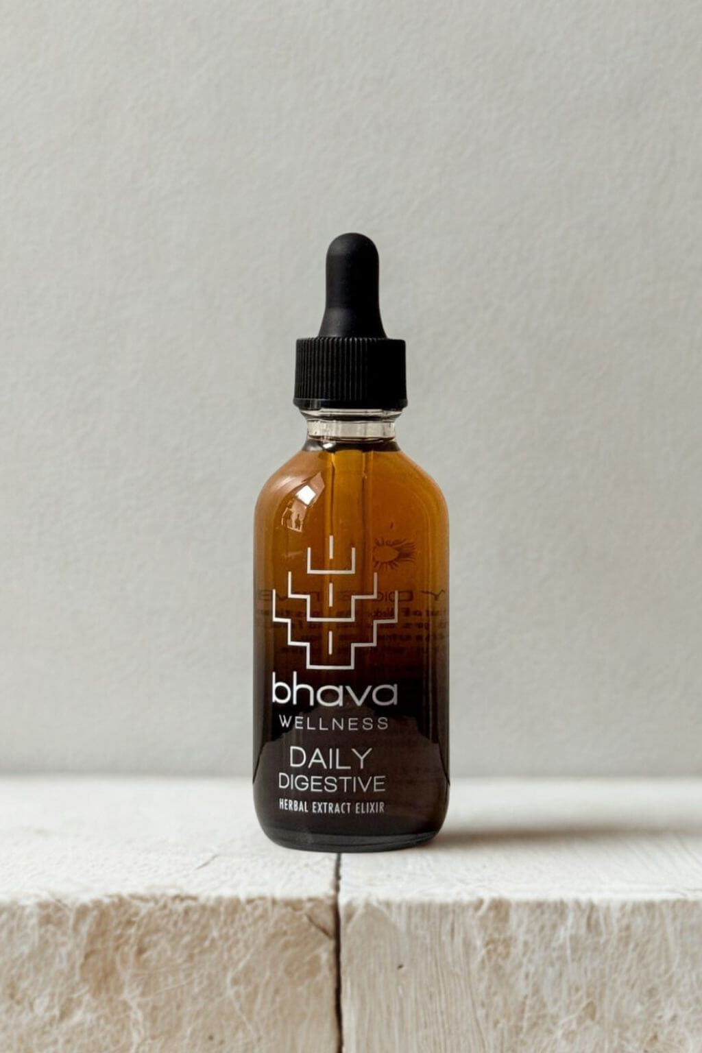 Bhava Wellness Daily Digestive bottle on a light wooden surface with a neutral background