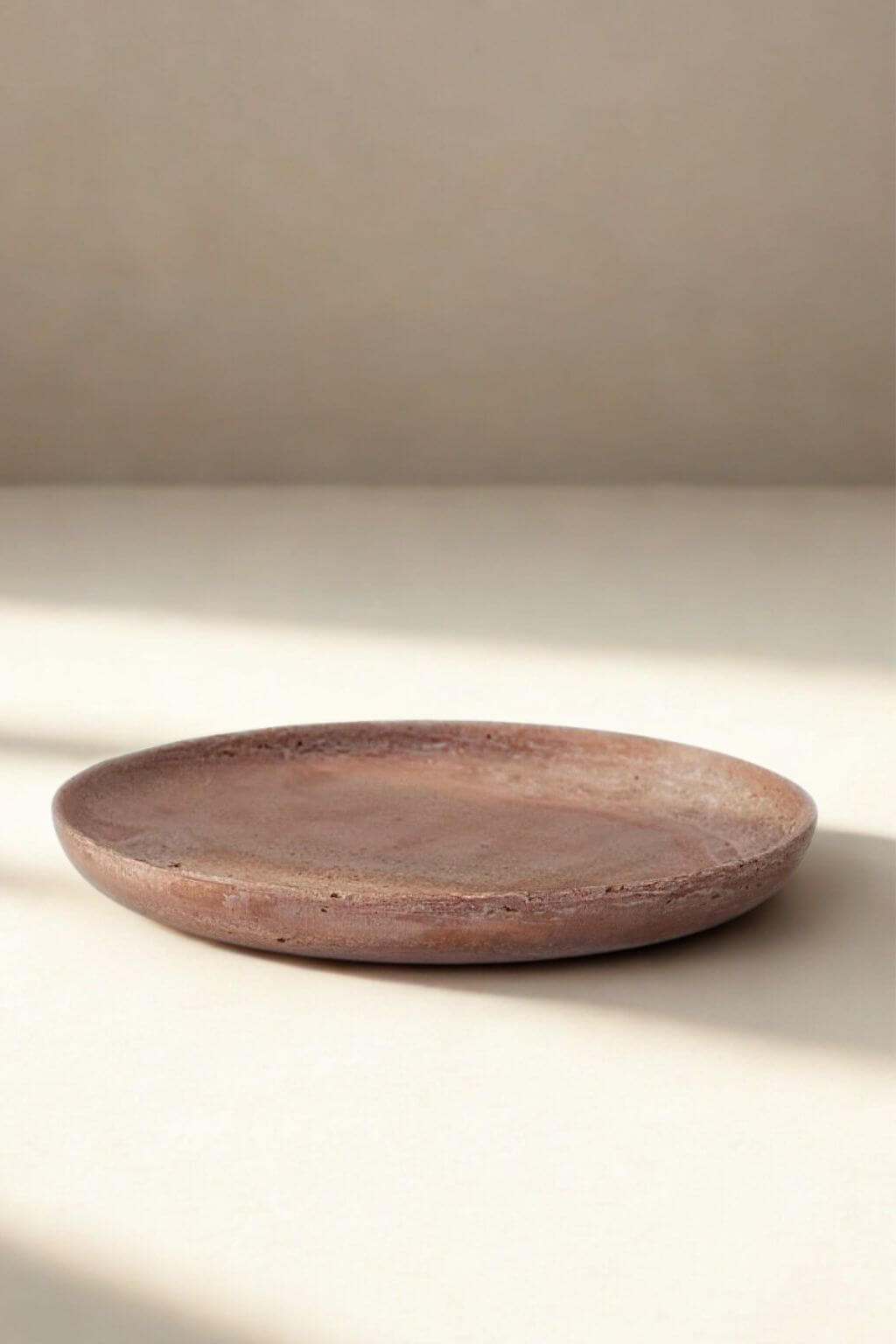 Natural red travertine stone tray with soft earthy tones and organic texture.