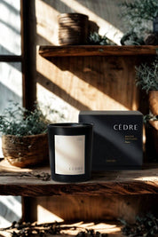 Cedar Luxury Candle displayed on a rustic wooden shelf with baskets and greenery in the background.