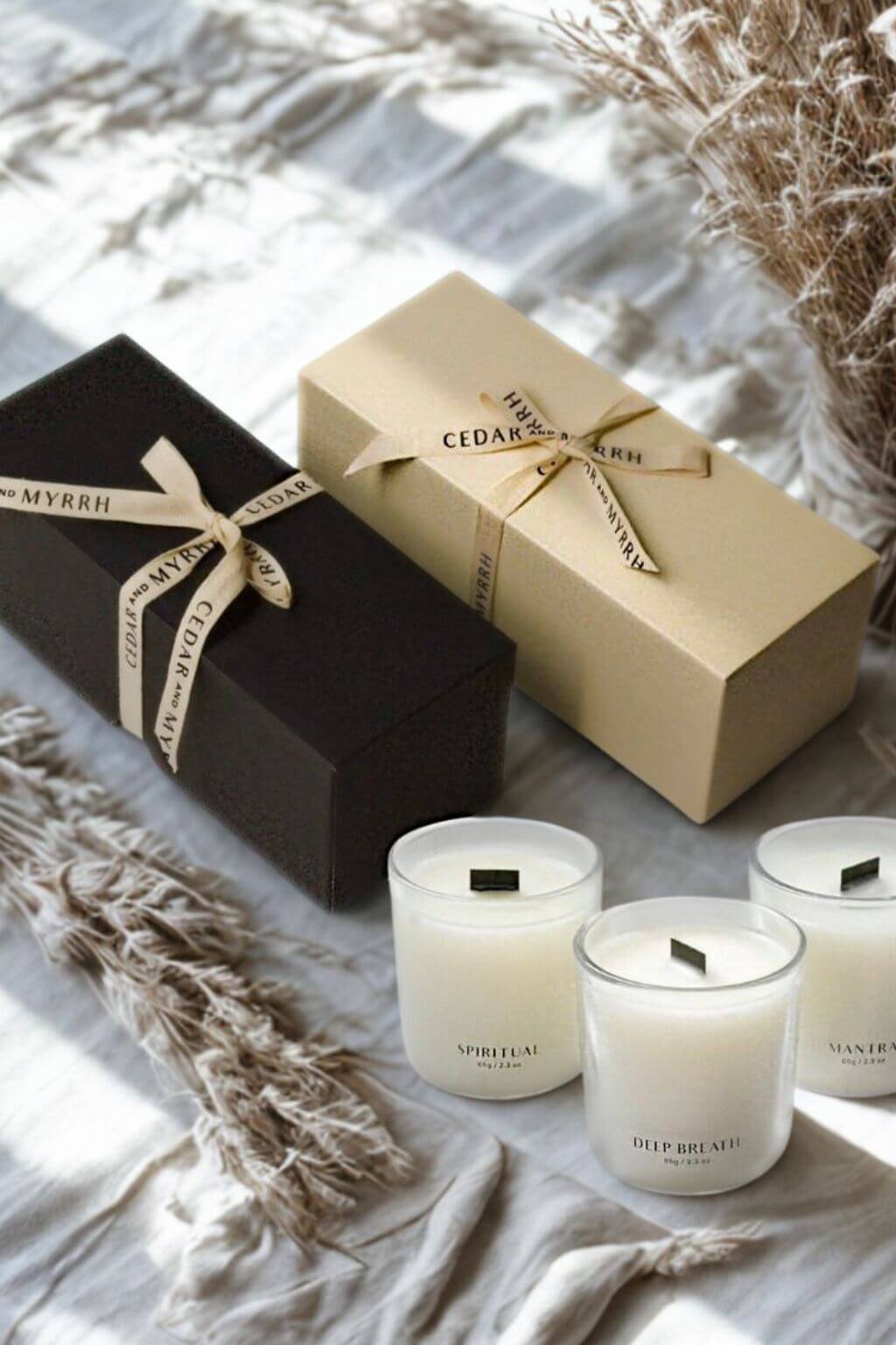 Mini Wellness Candle Gift Set with black and cream gift boxes alongside three glass votive candles labeled Spiritual, Deep Breath, and Mantra.