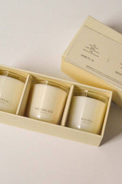 Buttercream gift box opened to reveal three mini candles—Spiritual, Deep Breath, and Mantra—arranged in individual compartments.