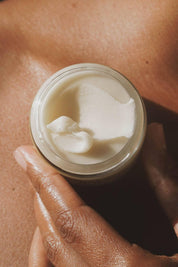 Hand scooping soft whipped deodorant from jar