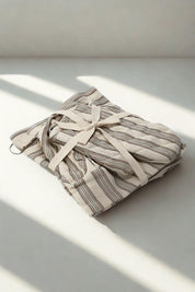 Little baker kitchen set folded and tied, natural light shadows