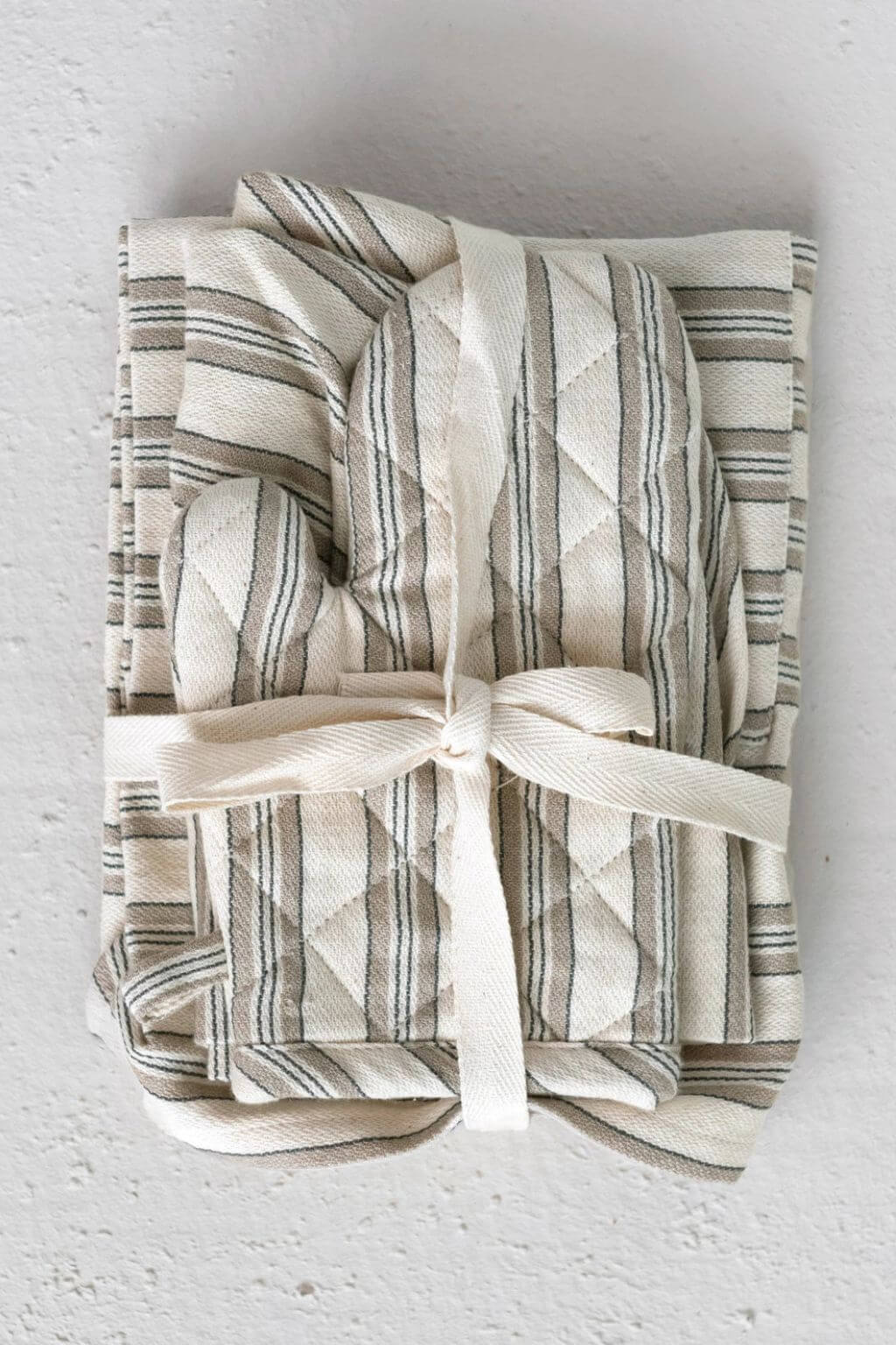 Folded children’s apron set tied with cotton ribbon