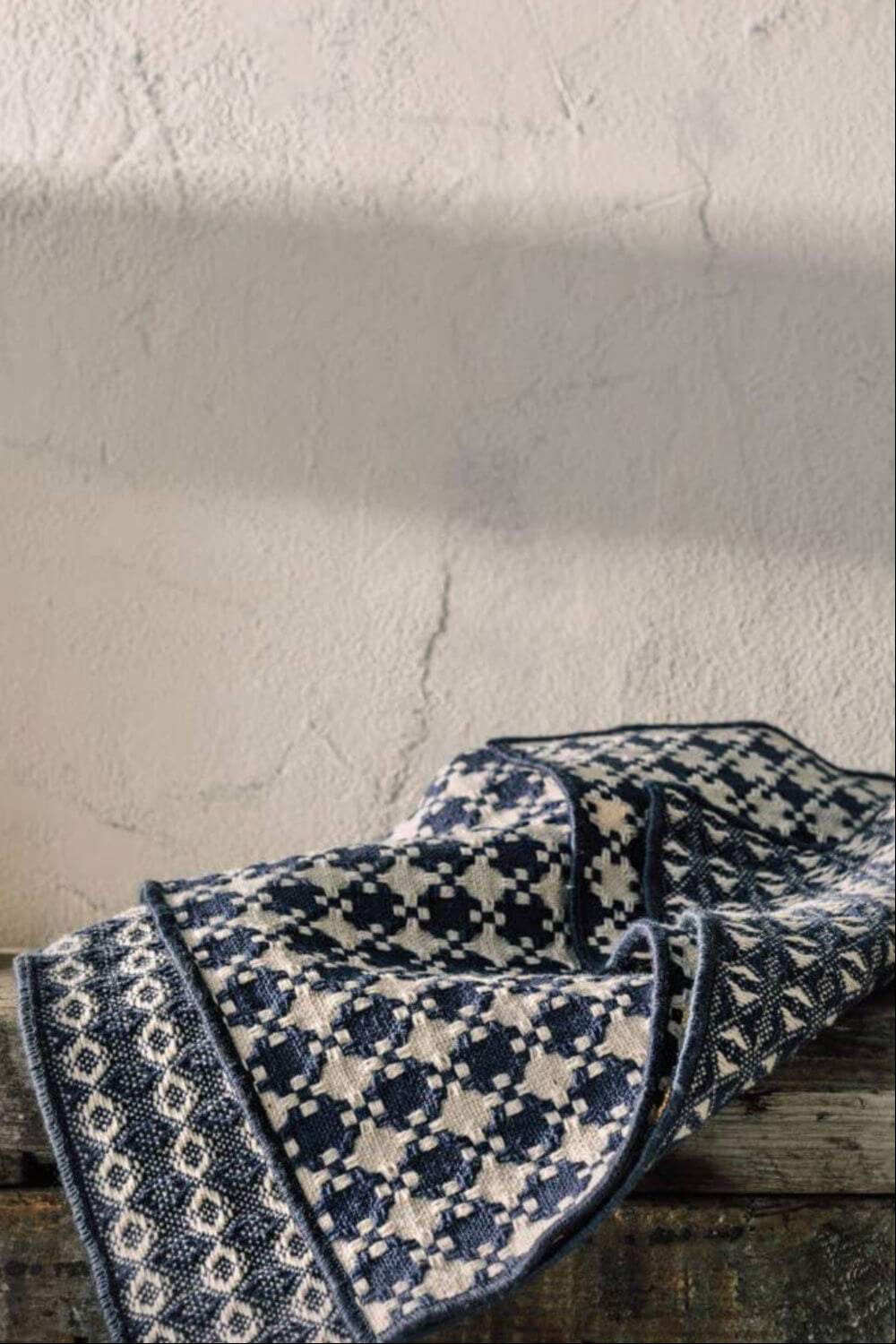 Midnight Blue Woven Dishcloths draped casually on a rustic wooden surface, highlighting their textured weave.