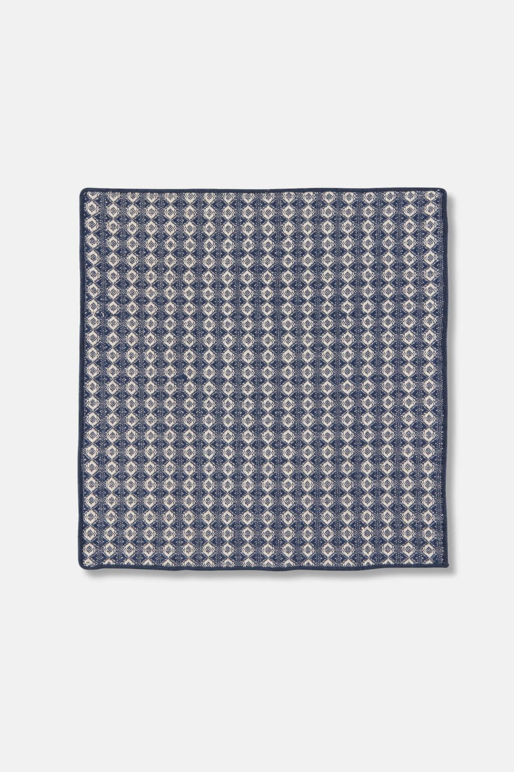 Close-up of woven dishcloth in midnight blue and cream pattern, made from cotton.