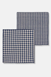 Flat-lay of two patterned woven dishcloths, part of a midnight blue cotton set.