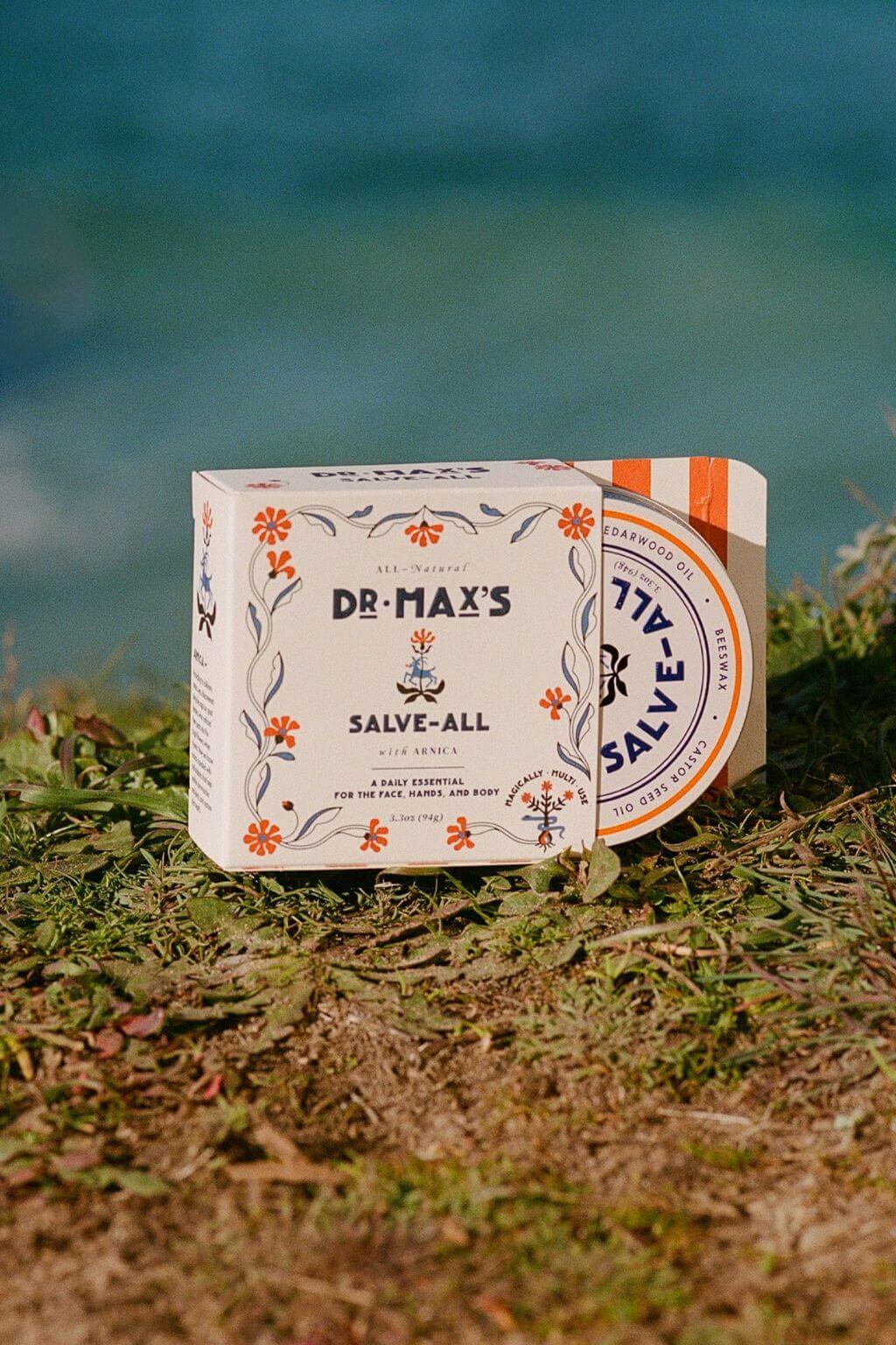 Dr. Max’s Salve-All packaging by the water outdoors