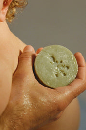 Parent holding Dr. Max’s olive oil soap bar during bath
