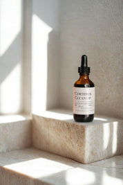 Cortisol Cleanup Tincture on sunlit stone surface with soft natural light