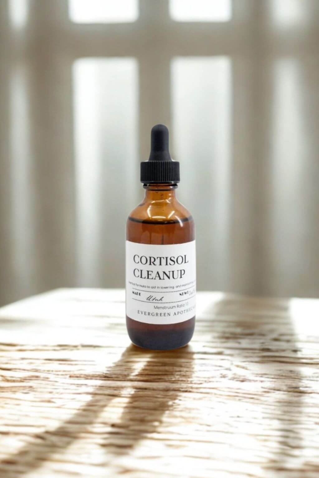 Cortisol Cleanup Tincture amber dropper bottle on rustic wooden surface in sunlight
