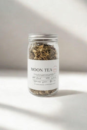 Evergreen Apothecary Moon Tea jar against soft white background with sunlight shadows