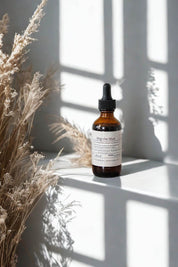 Herbal tincture Skip the Shot with dried grasses and shadows in natural light