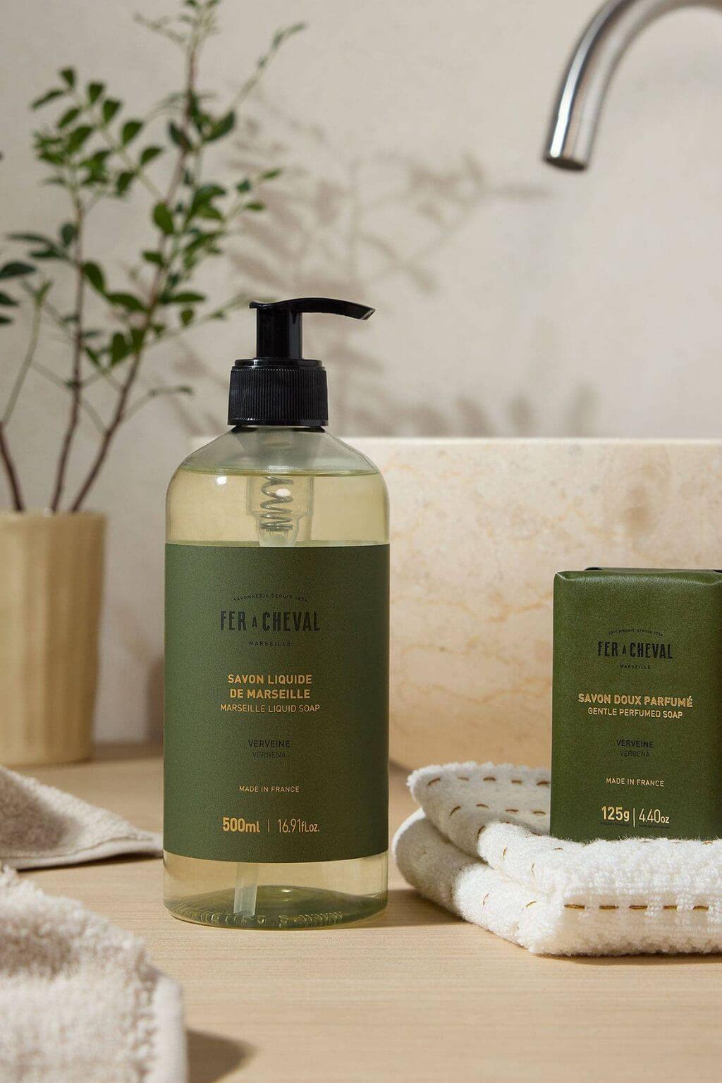 Fer à Cheval Verbena Marseille Liquid Soap and soap bar with towel by sink.