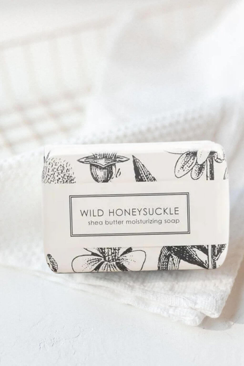 Wild Honeysuckle shea butter soap wrapped in vintage floral botanical paper on white linens.