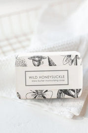 Wild Honeysuckle shea butter soap wrapped in vintage floral botanical paper on white linens.