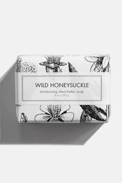 Close-up of Wild Honeysuckle soap with vintage illustration packaging.