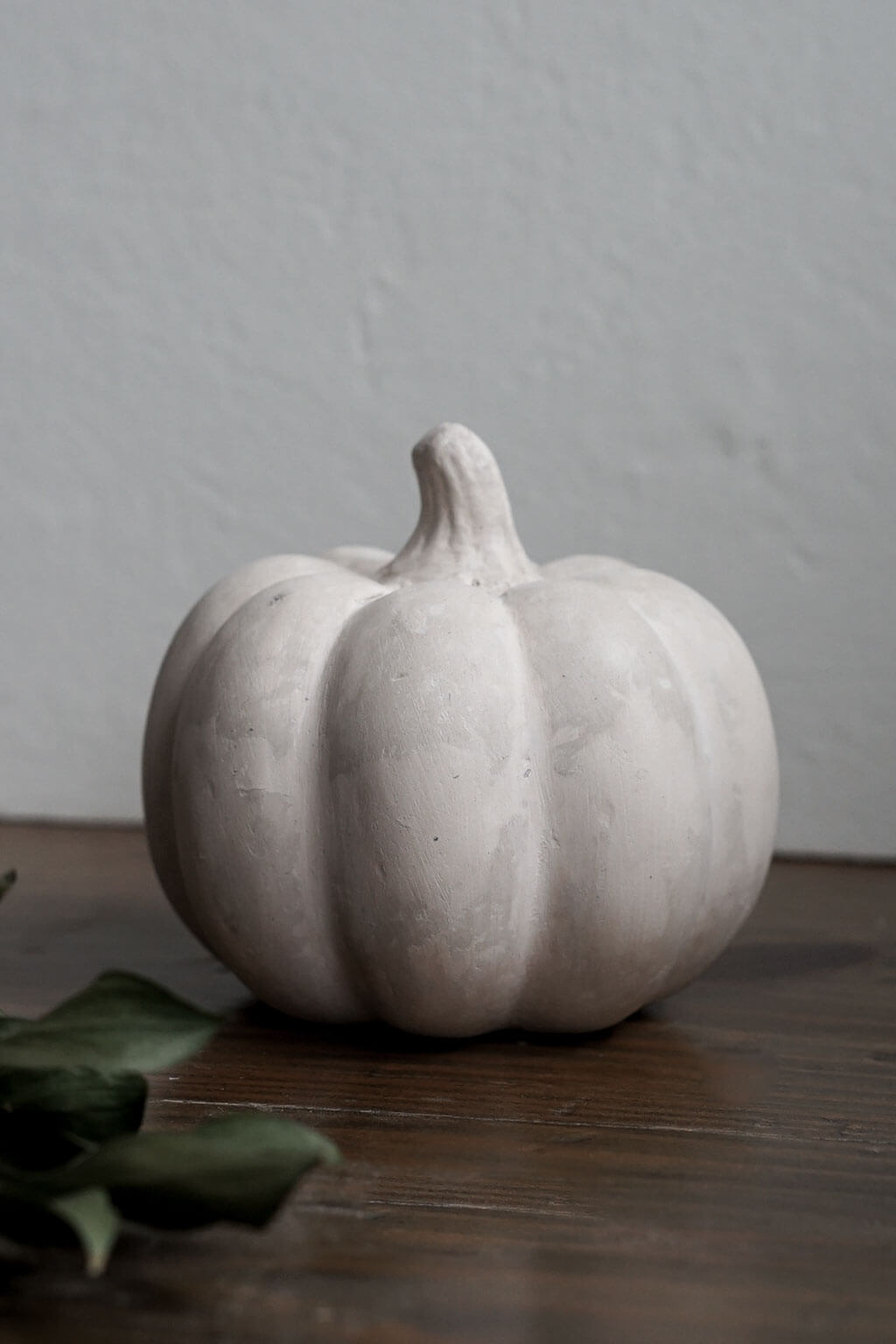 Fall décor pumpkin made with sustainable material on a wooden surface