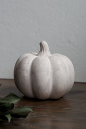 Fall décor pumpkin made with sustainable material on a wooden surface